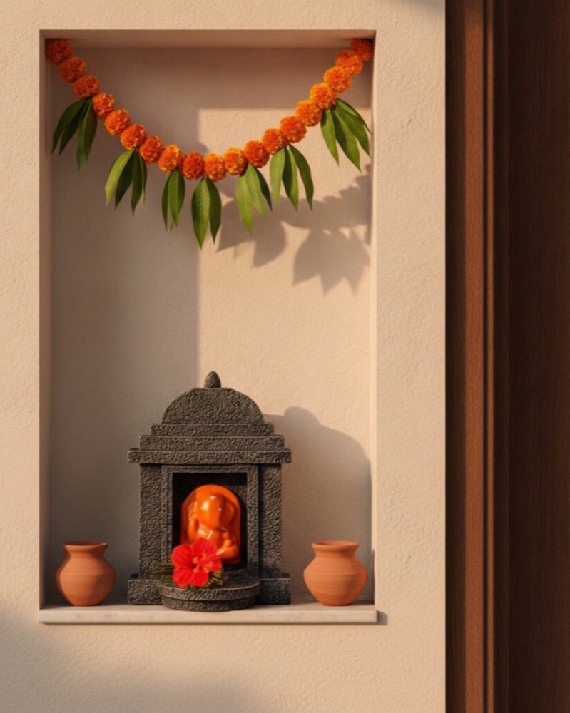 The shrine below a mango leaf toran.